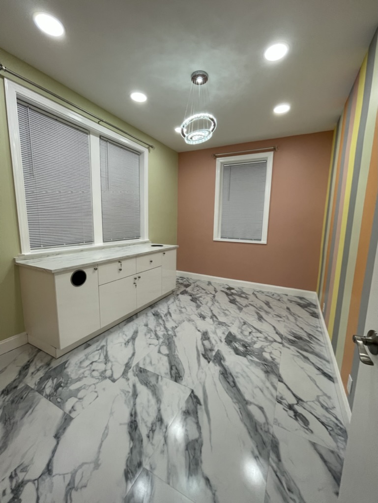 Service room with new windows, cabinetry, and decorative lighting