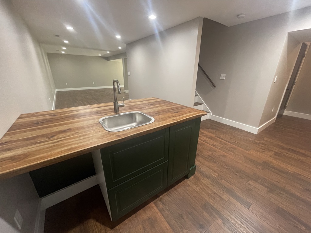Custom wet bar with sink and butcher-block countertop
