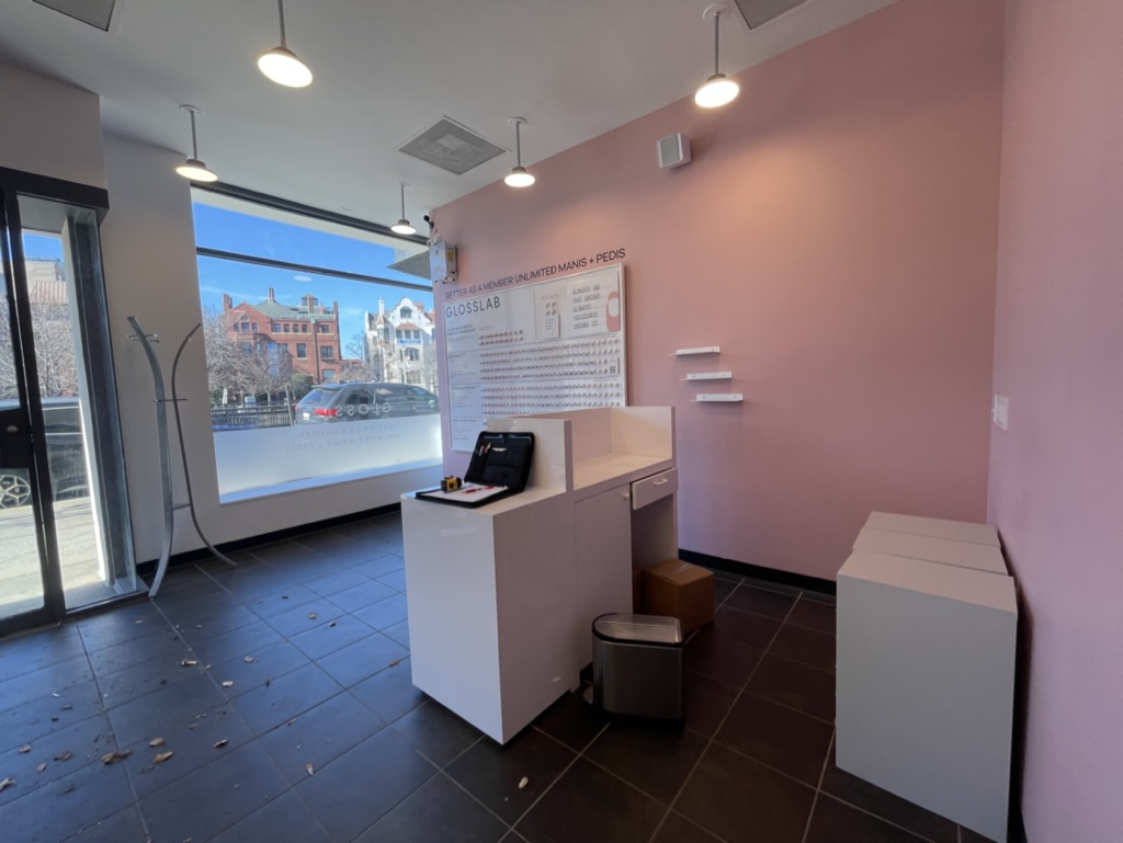 Completed reception and entry area with custom desk and pendant lighting