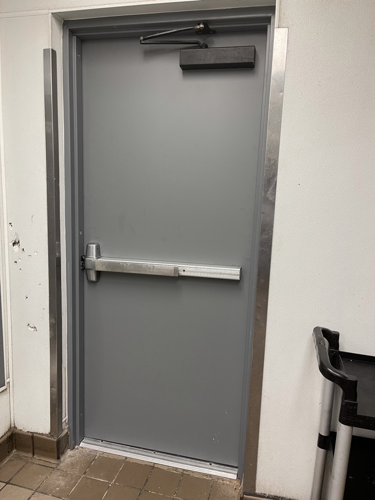 Completed interior view – new commercial door with panic bar and closer installed