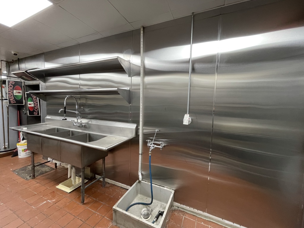 Completed repair – new stainless-steel wall finish with sink reinstalled