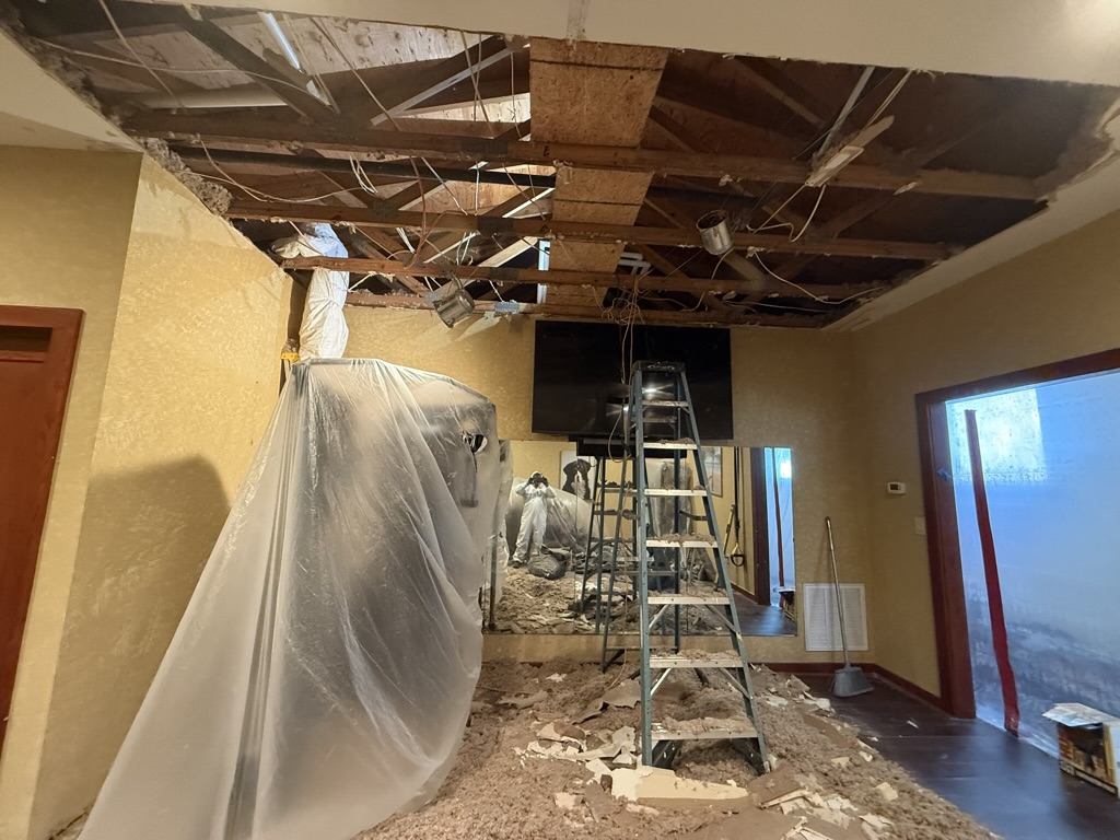 Demolition and cleanup with damaged drywall and wet insulation removed