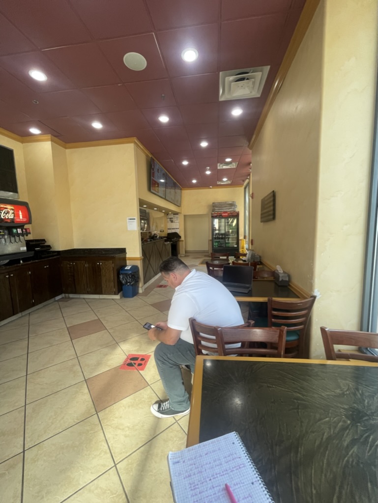 Existing restaurant interior showing the previous dark red suspended ceiling and original finishes