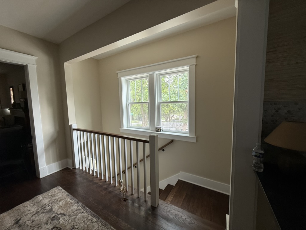 Finished upper landing with railing system and hardwood flooring