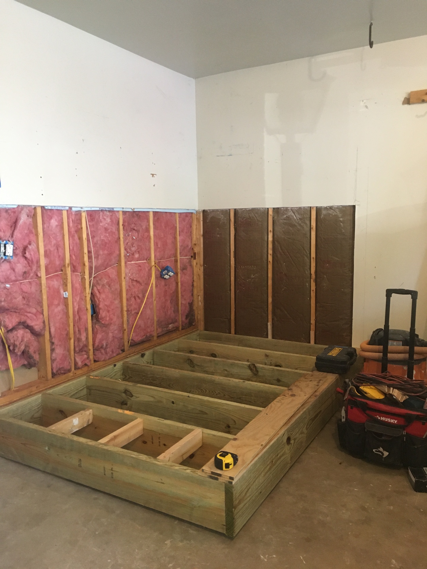 New bathroom addition floor platform construction inside existing garage