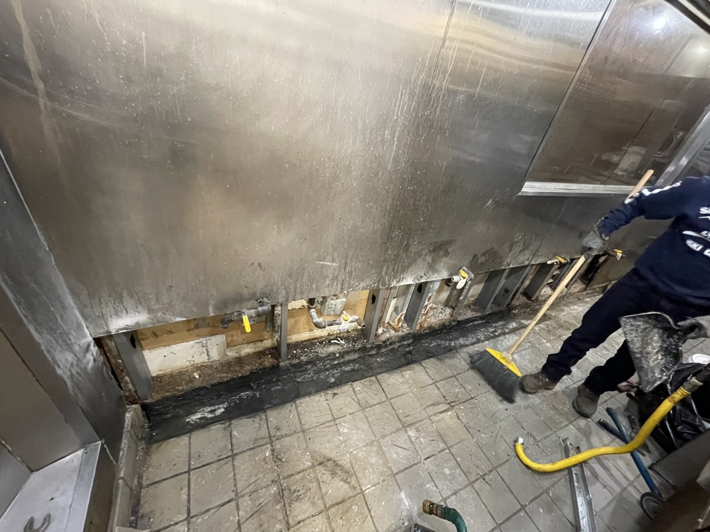 REPAIR IN PROGRESS — Lower wall section opened for repair of damaged wall components.