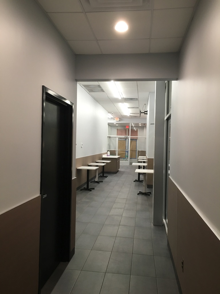 Finished interior circulation area with commercial tile flooring and wall finishes