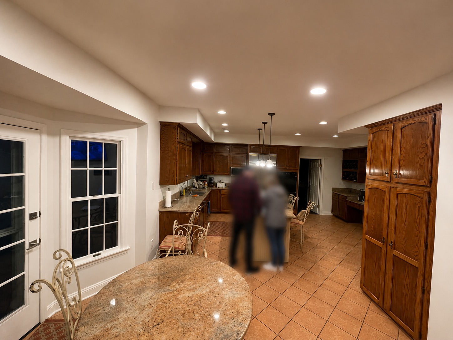 Existing kitchen before renovation — outdated cabinetry, tile floors, soffits, and closed layout