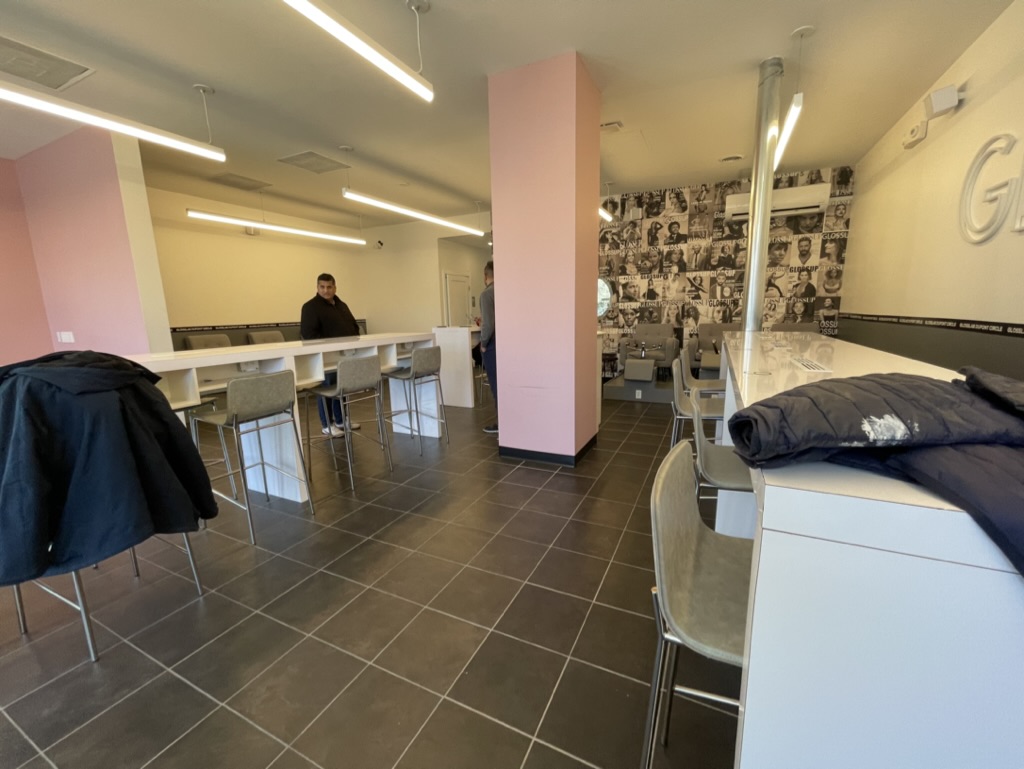 Completed manicure bar with counter seating and feature wall