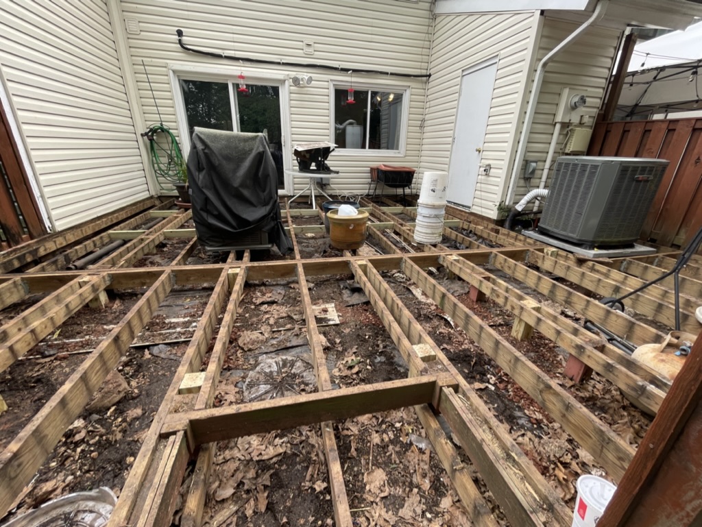 Deck demolition with framing exposed for inspection