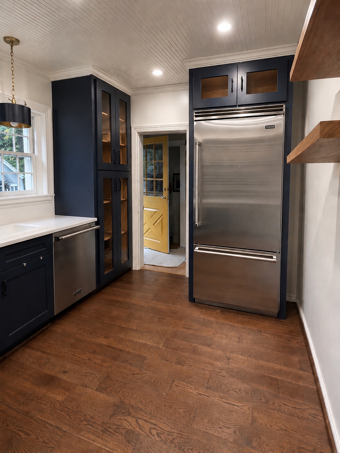 Custom pantry and refrigerator enclosure finished to match the homeowner's selected cabinetry