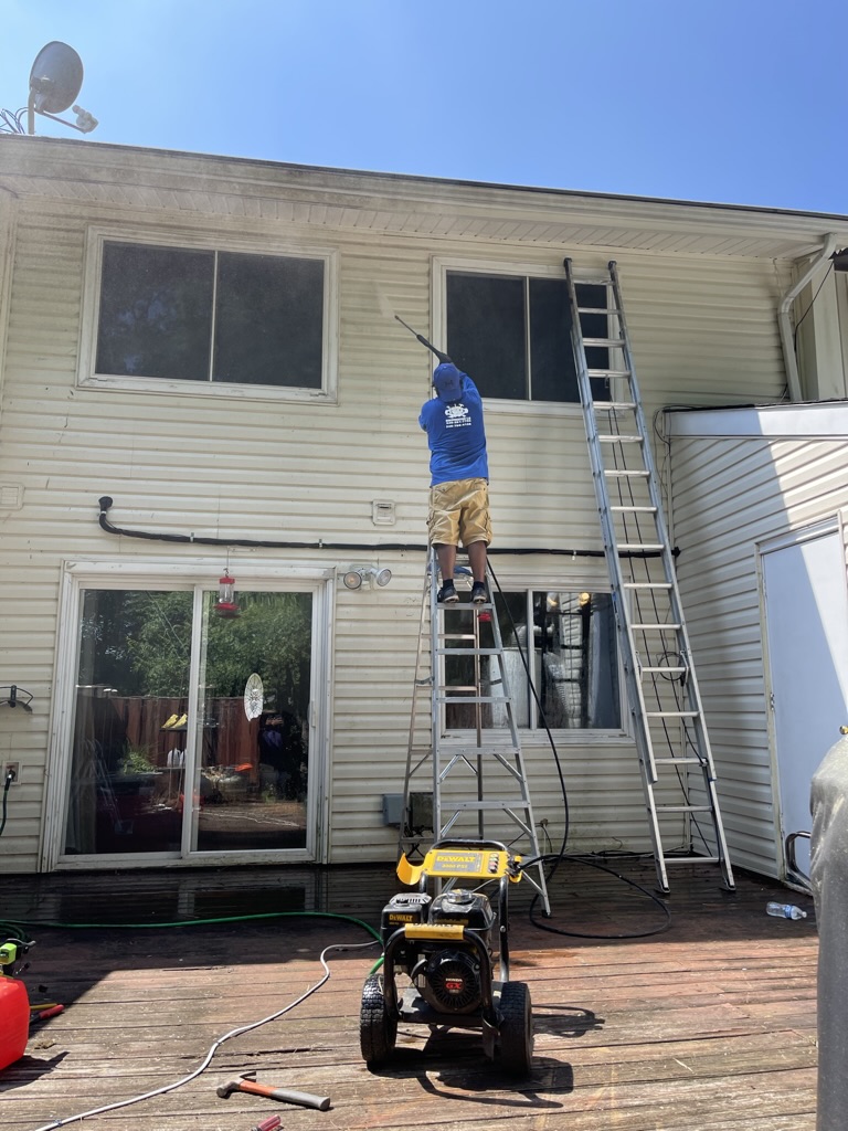 Pressure washing the rear exterior siding