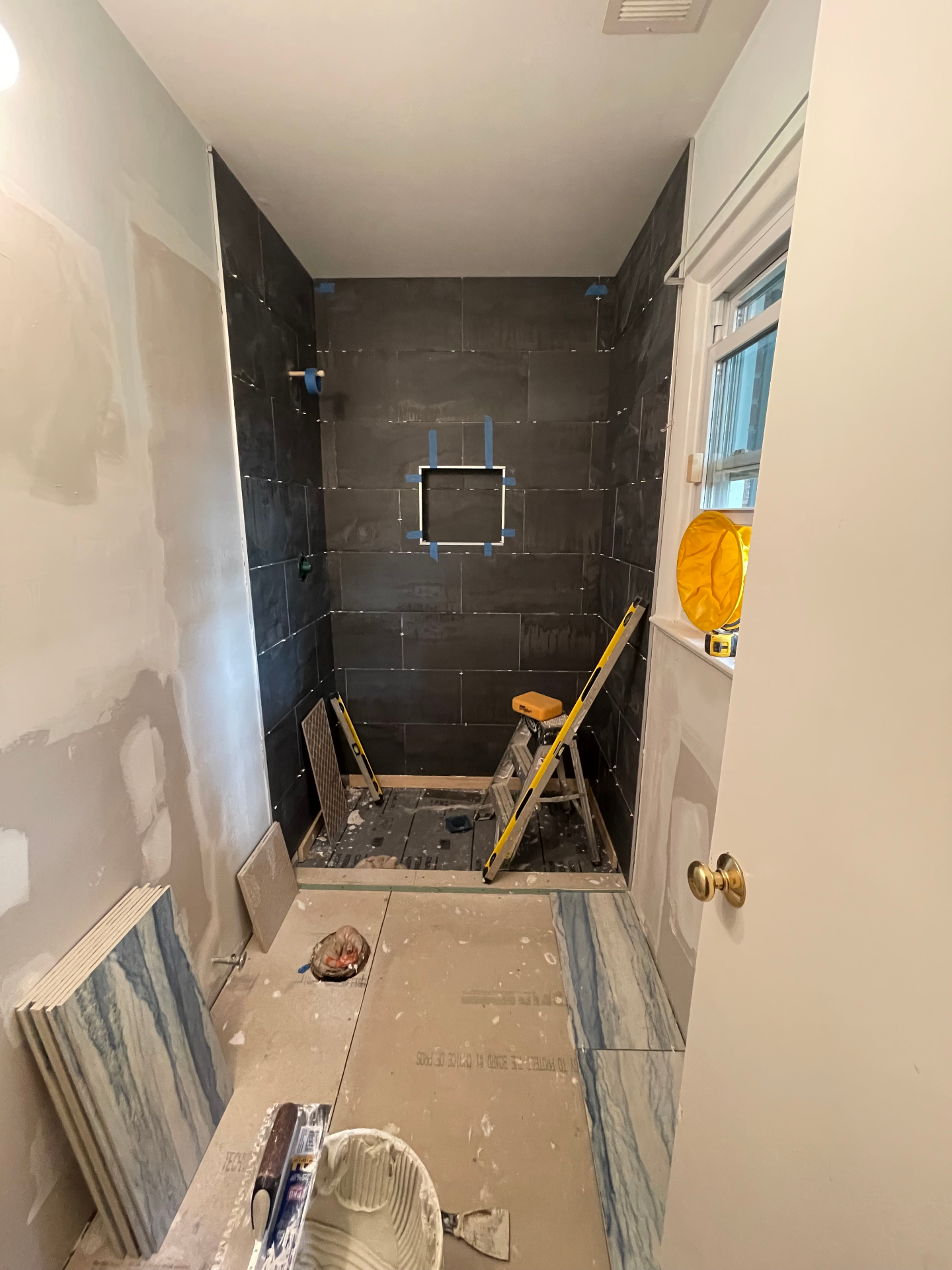Walk-in shower construction and tile installation in progress