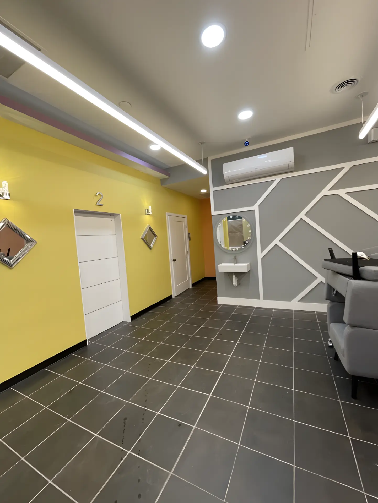 Completed service corridor with private treatment rooms and accent wall detail