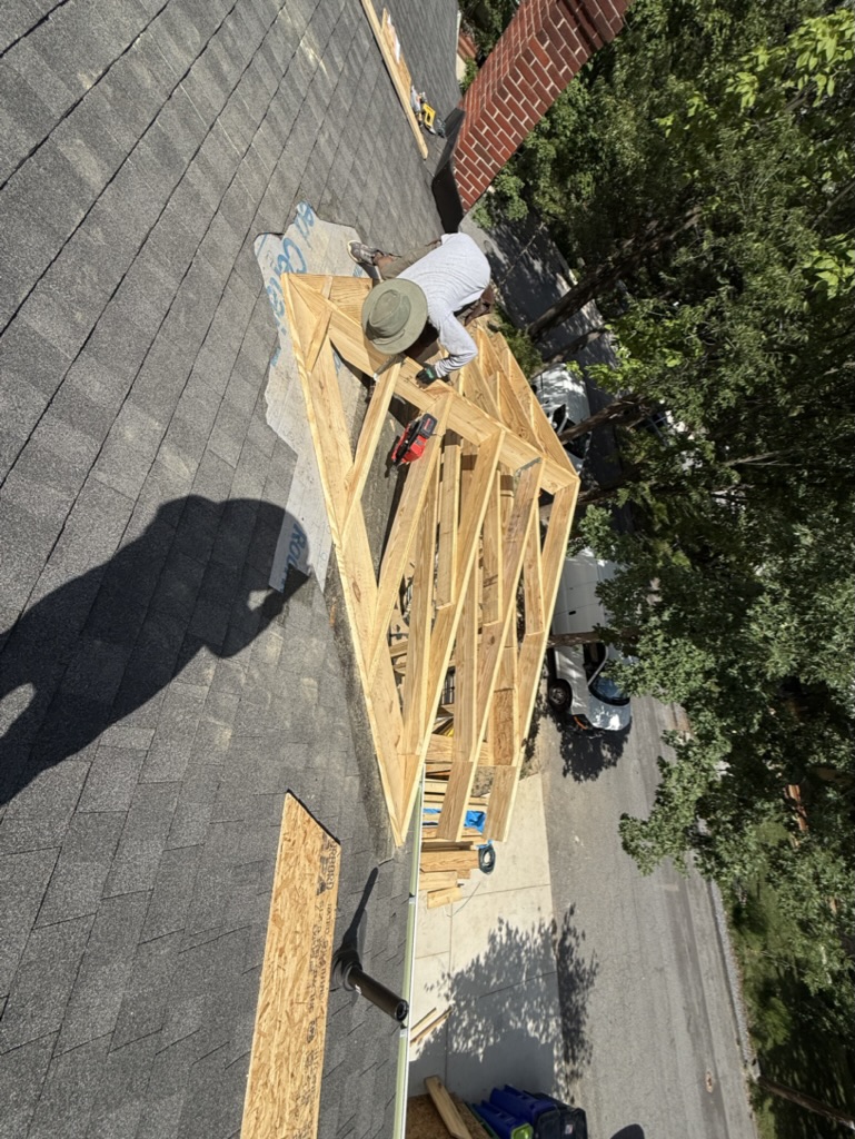 Roof framing assembled on site and integrated with the existing roofline