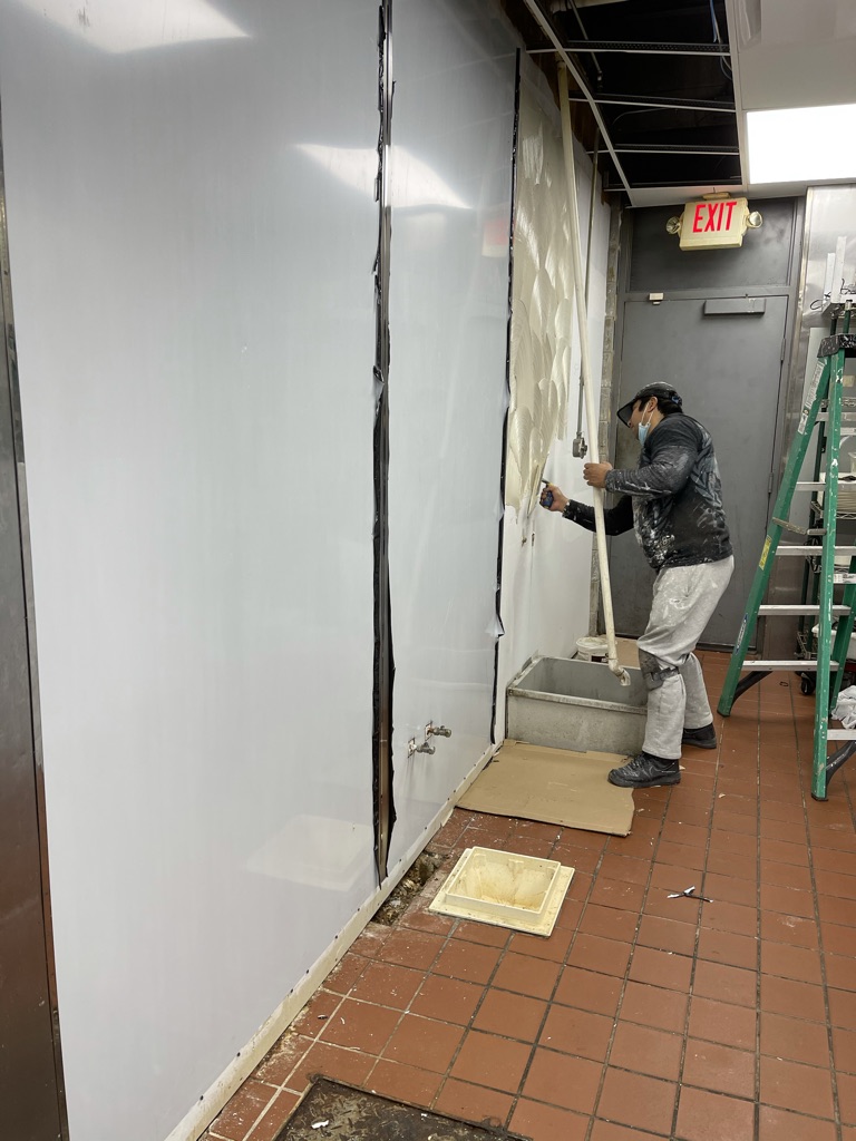 Finishing phase – stainless-steel wall panels being installed