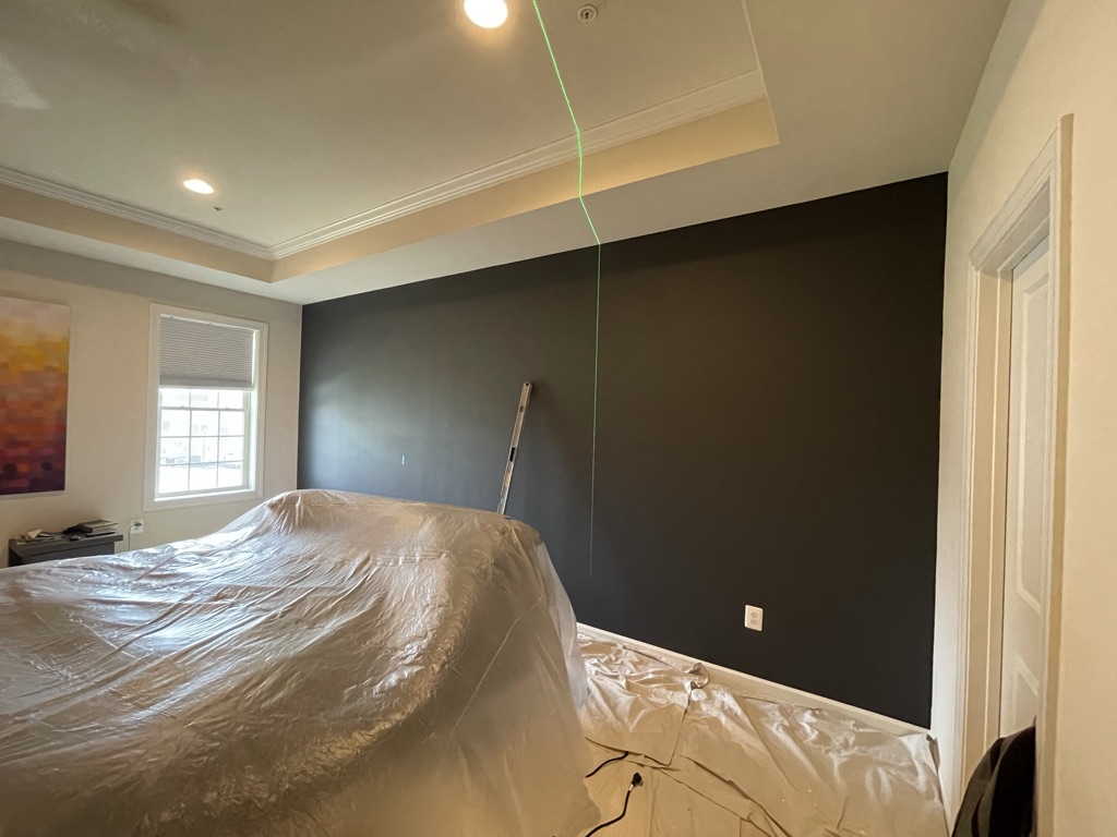Accent wall painting in progress with premium dark finish