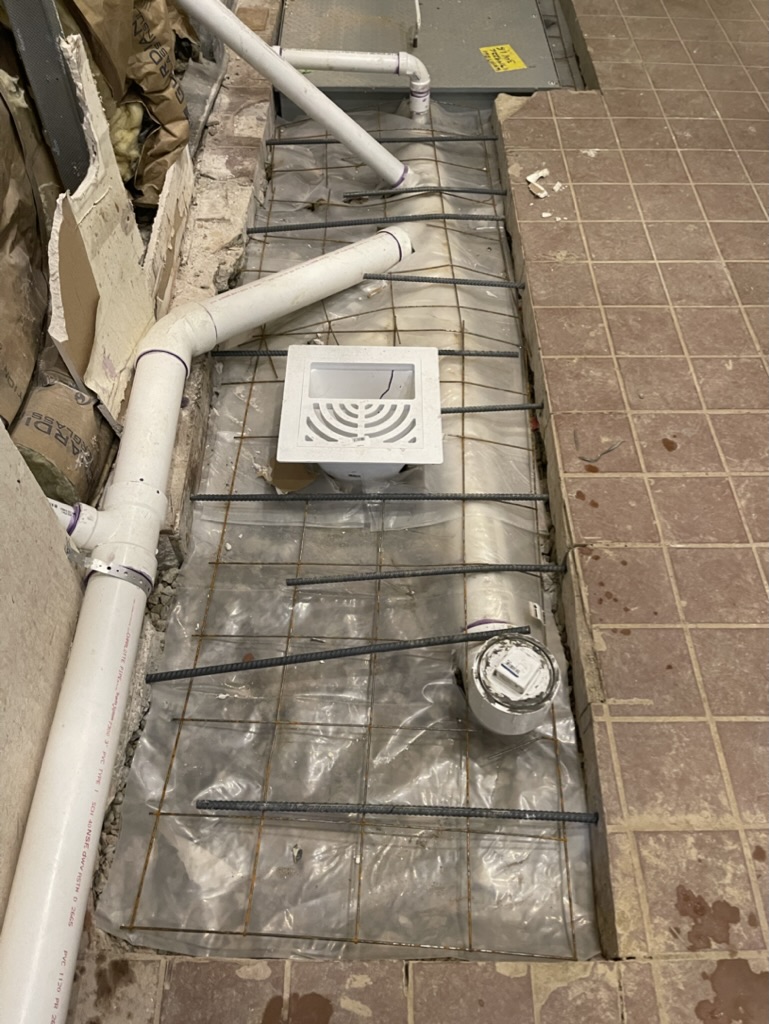 New drain lines and grease waste piping installed below the slab