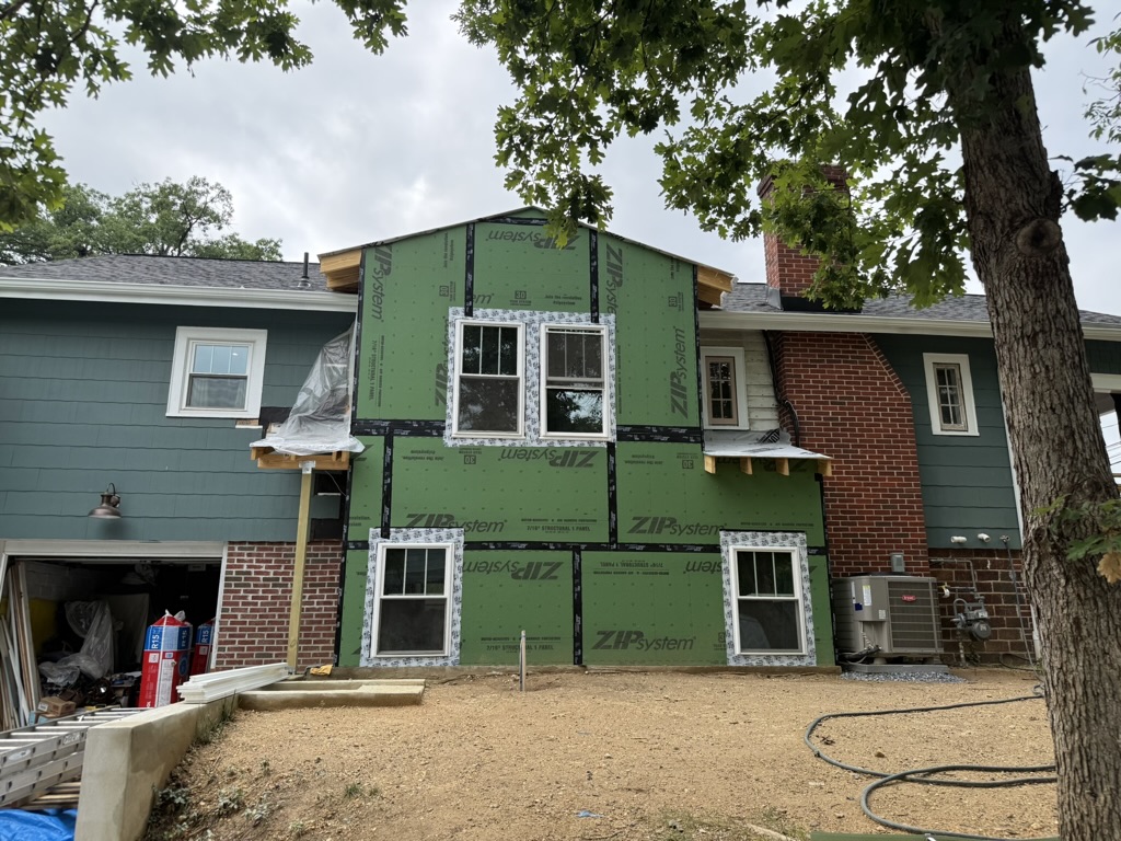 Exterior sheathing and weather protection installed, windows set and flashed