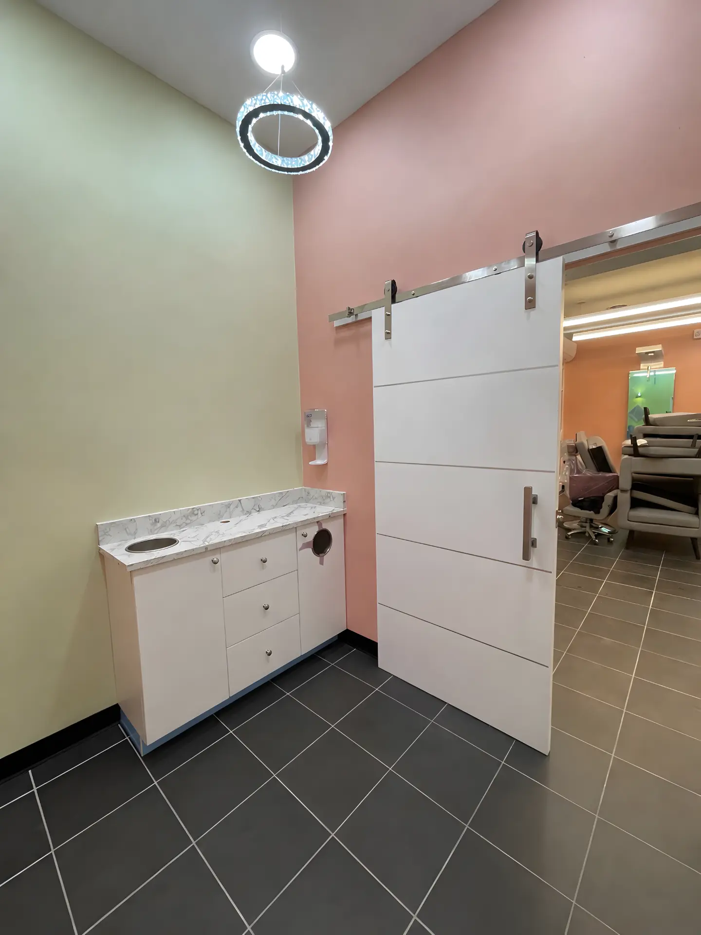 Completed treatment area with cabinetry, countertop, and sliding barn-style door