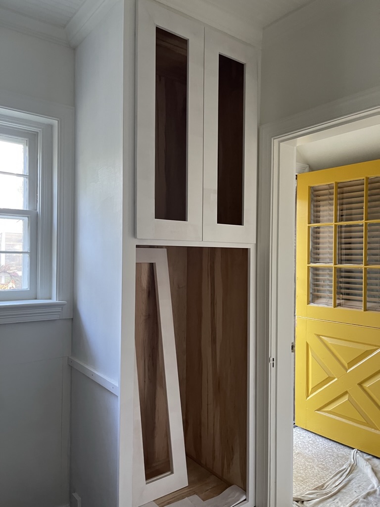 Custom floor-to-ceiling pantry cabinetry built and finished on site