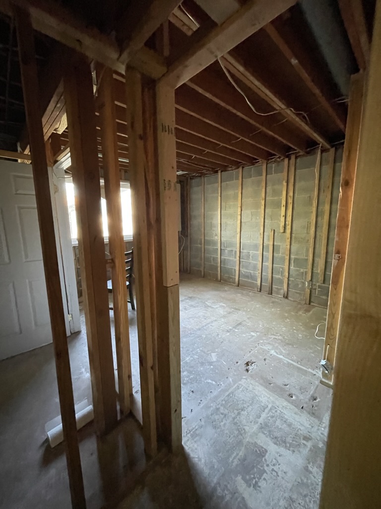Unfinished basement prior to installing drywall, flooring, and interior finishes