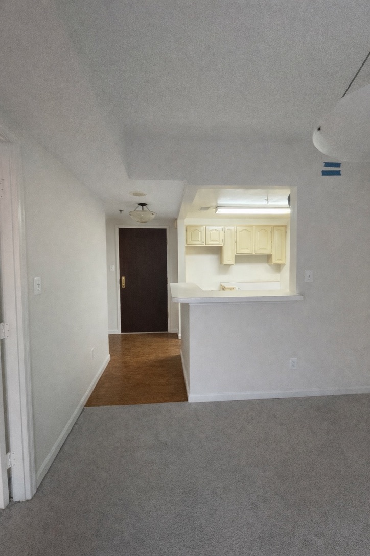 Existing living area and entry before renovation