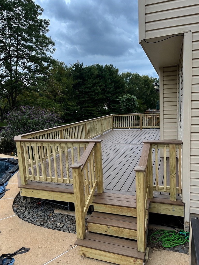 Completed expanded composite deck with new pressure-treated wood railing