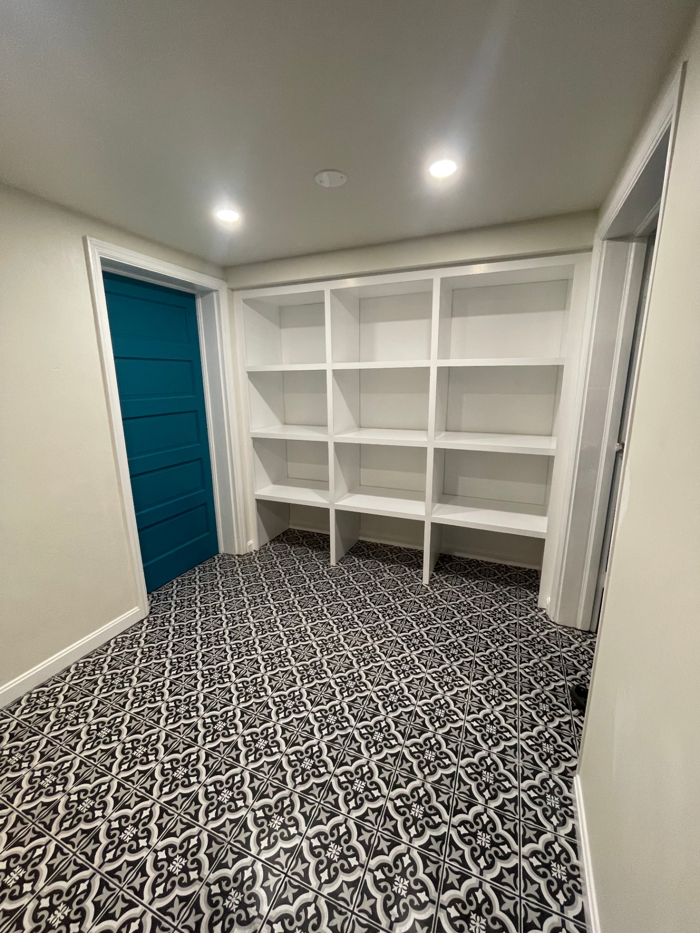 Custom built-in shelving completed in finished basement hallway