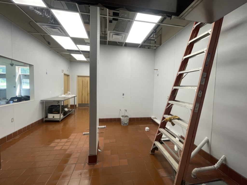 FRP wall finishes, ceiling grid, and utility areas nearing completion