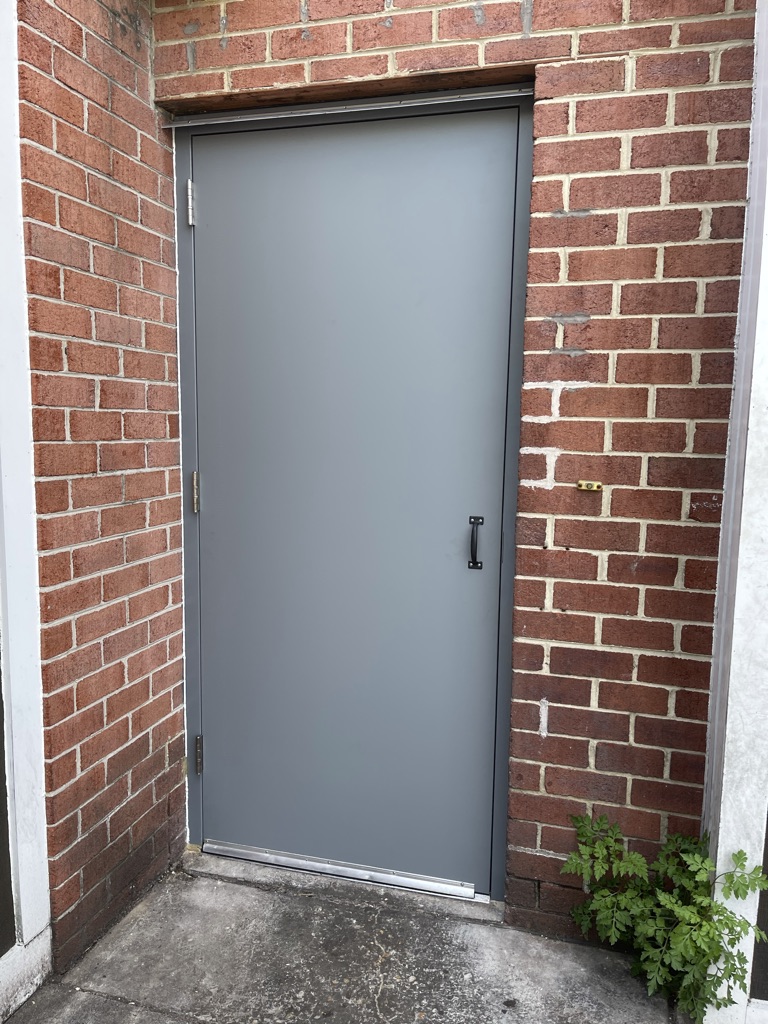 Completed exterior view – new rear metal access door installed and finished